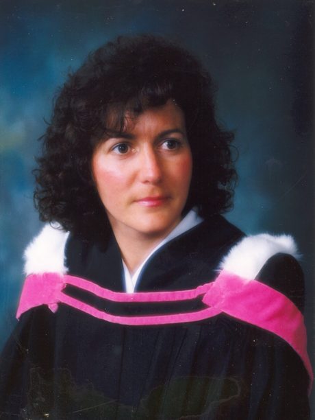 Graduation portrait of a young Paula in academic regalia.